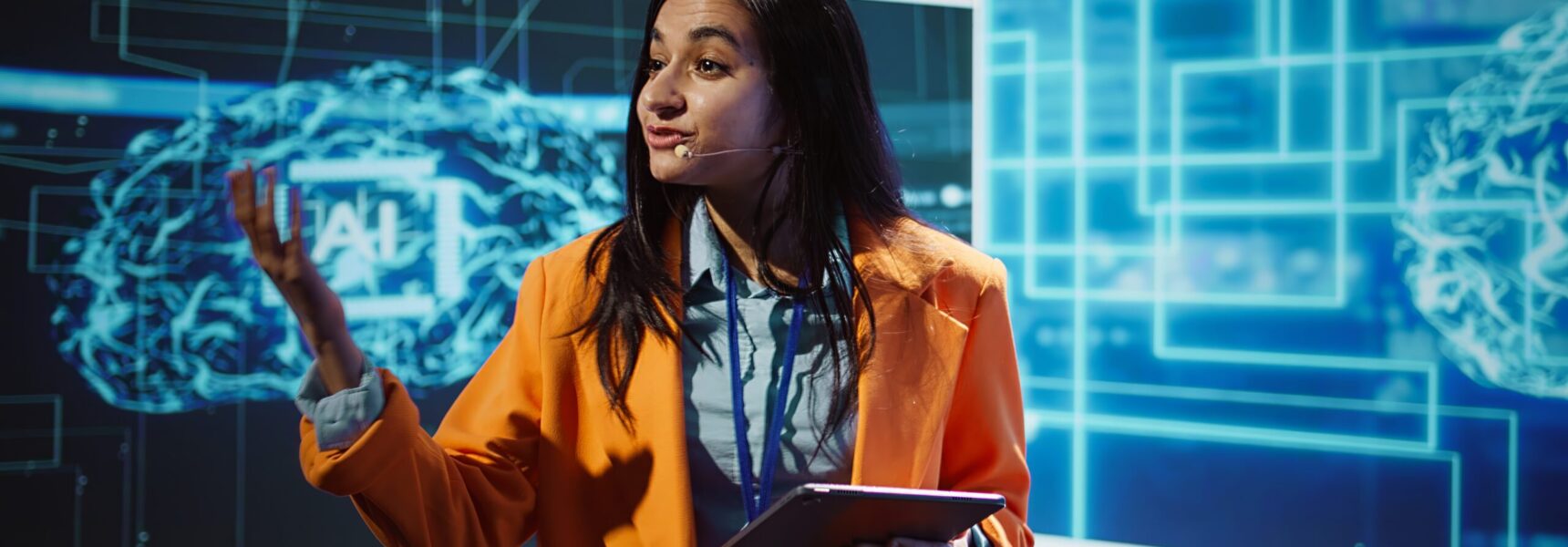 Public speaker doing presentation at tech forum event, explore ways emerging AI technologies can positively enhance companies workforce. Indian woman promoting artificial intelligence solutions